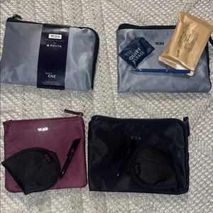 Tumi Travel Pouch Set in Gray, Burgundy, and Black